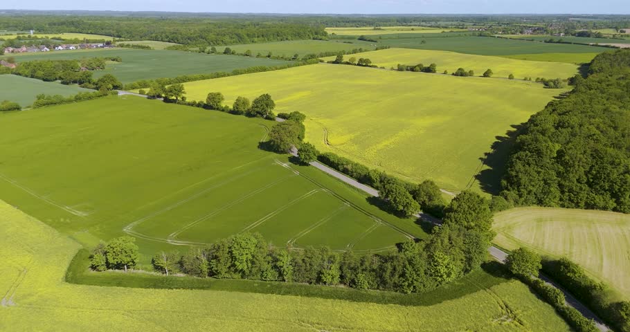 different fields and forest in germany landscape arieal with a blue sky and little clouds