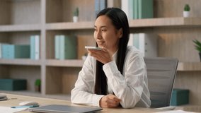 Joyful Chinese businesswoman worker Korean Japanese business woman female manager using mobile phone online app call talking smartphone speakerphone recording voice recognition message send SMS indoor - Powered by Shutterstock - Get 15% off with code: PIKWIZARD15