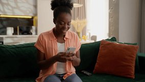 Laughing happy celebrating African American woman ethnic female businesswoman girl smiling winner holding mobile phone celebrate smartphone victory win cheering gesture scream shouting success at home - Powered by Shutterstock - Get 15% off with code: PIKWIZARD15