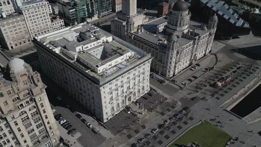 Explore the vibrant waterfront of Liverpool with a bustling view of architecture and activity along the shore