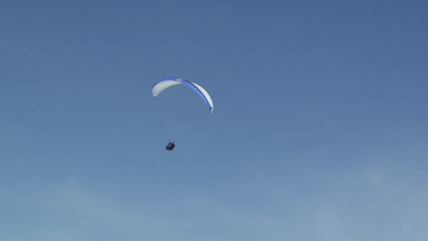 A paraglider comes into land