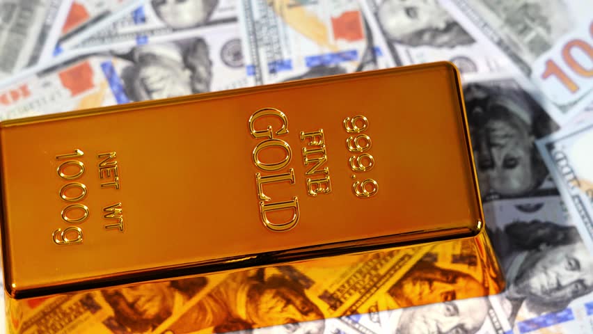 A gold bar on the background of dollars. Gold and foreign exchange reserves.