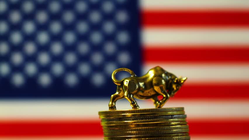 The bull is the symbol of the stock exchange, against the background of the US flag.