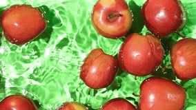 Whole red apples falling into water, splash water, slow motion. - Powered by Shutterstock - Get 15% off with code: PIKWIZARD15