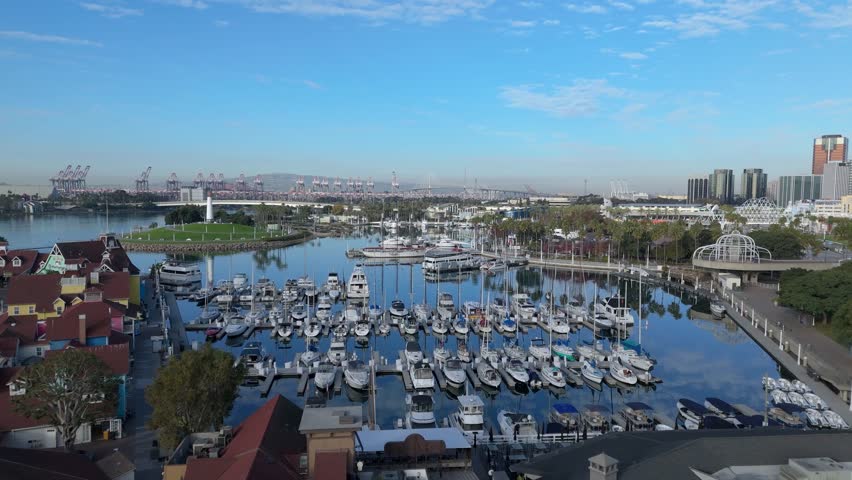 Aerial view of Rainbow Harbor and Long Beach cityscape at dawn with clouds in the sky, Long Beach, California