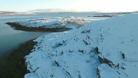 Drone captures frozen landscape of the Kola Peninsula in Russia during winter, showcasing endless snowfields, tundra, and northern lights-like hues. - Powered by Shutterstock - Get 15% off with code: PIKWIZARD15