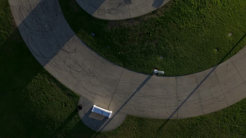 Aerial establishing shot of Lions Lighthouse at Shoreline Park in Long Beach, California, as dawn lights up the peaceful harbor and stunning skyline.