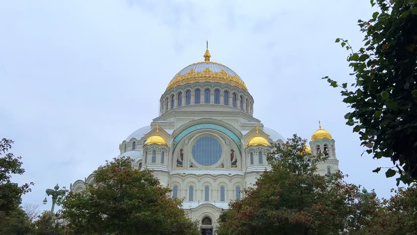KRONSTADT, Russia - September 14, 2024: St. Nicholas Naval Cathedral. The Kronstadt Naval Cathedral on Yakornaya Square in cloudy weather in autumn. Autumn Kronstadt. Kotlin Island. 4K