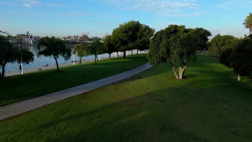 Aerial view of Shoreline Park in Long Beach, California, as dawn lights up the peaceful harbor and stunning skyline.