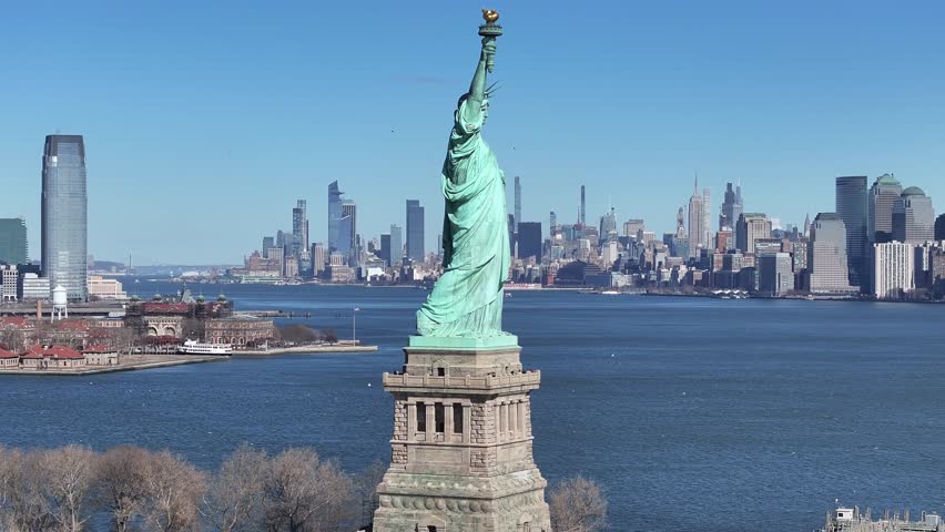 Liberty Statue At Manhattan New York United States. Aerial Landscape Of Famous Statue In A Natural Scenery. Town Sky Clouds Backgrounds Urban. Outside Backgrounds Panning Wide. Manhattan New York.