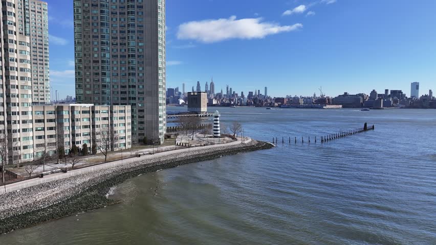 Lighthouse Point At Jersey City New Jersey United States. Lighthouse Standing Tall On Beach With Ocean Waves Crashing. Business Clouds Sky Downtown Cityscape. Backgrounds Panorama.