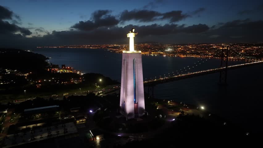 King Christ At Almada District Of Lisbon Portugal. Aerial Landscape Of Famous Statue In A Natural Scenery. Night Expressway Downtown Cityscape. Night Outside Downtown. Almada District of Lisbon.