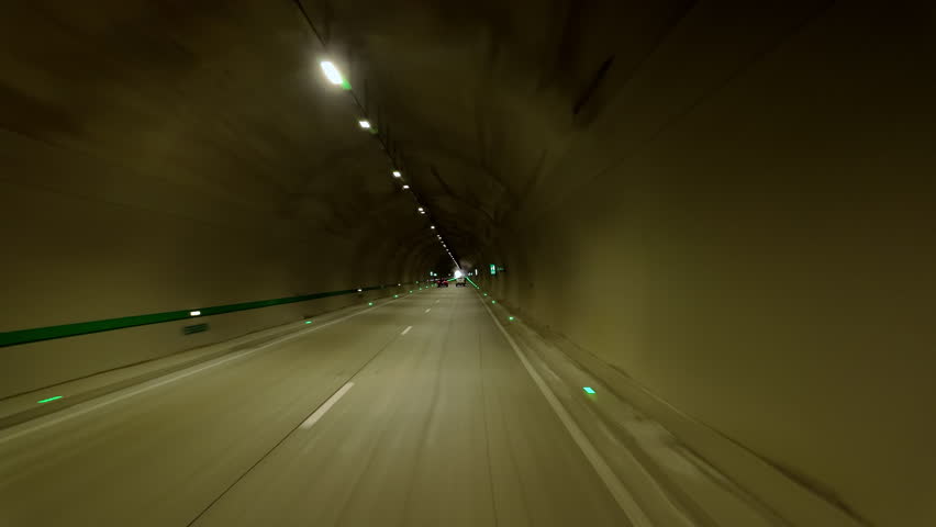 Driving along road inside car tunnel.