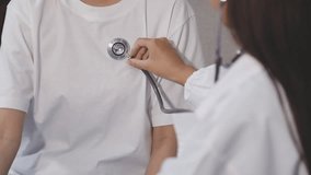 Homecare nursing service and elderly people cardiology healthcare. Close up of young hispanic female doctor nurse check mature caucasian man patient heartbeat using stethoscope during visit - Powered by Shutterstock - Get 15% off with code: PIKWIZARD15