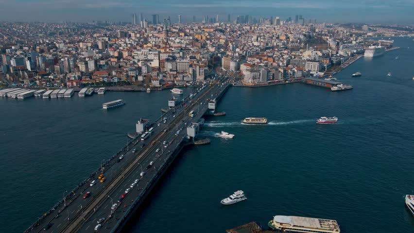 A Istanbul city with a bridge over a river and boats on the water