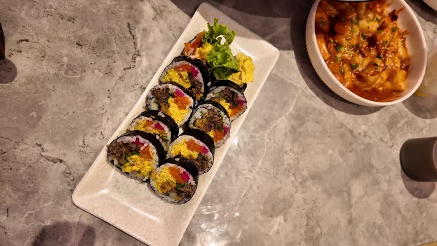 plate of delicious kimbap, a favorite Korean dish. Famous Korean Food.