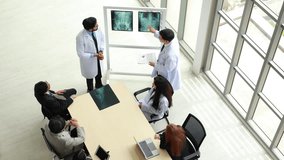 Hospital Medical training : Asian man doctor and nurse and healthcare professional team meeting sitting in boardroom, Planning and brainstorming health. Doctor giving lecture medical conference - Powered by Shutterstock - Get 15% off with code: PIKWIZARD15