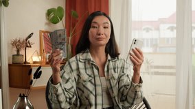 Asian Korean woman holding mobile phone smartphone money dollars bills choice choosing payment female businesswoman client internet order online finance business home Chinese Japanese girl indoor bank - Powered by Shutterstock - Get 15% off with code: PIKWIZARD15