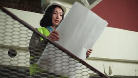 Frustrated Asian Korean woman female businesswoman builder read checking blueprint engineer inspector wrong mistake problem architect developer building plan sad girl sigh looking construction project - Powered by Shutterstock - Get 15% off with code: PIKWIZARD15