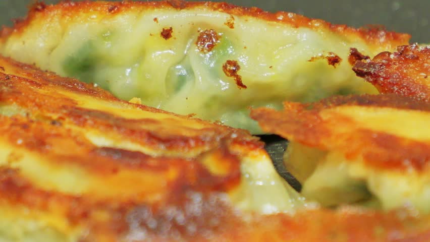 Delicious looking gyoza baked on a hot plate