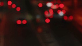 Abstract view of blurred red tail lights from moving traffic on a night city road. Soft bokeh effect against a dark urban background - Powered by Shutterstock - Get 15% off with code: PIKWIZARD15