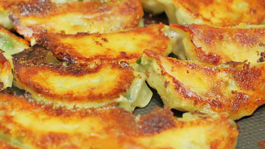 Delicious looking gyoza baked on a hot plate