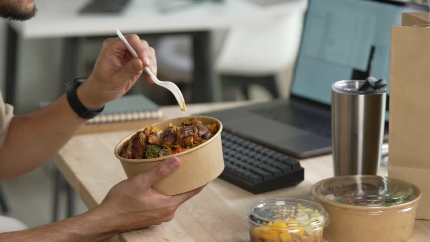 Man eating healthy meal while working, Businessman having a lunch break at the office