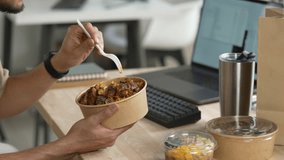 Man eating healthy meal while working, Businessman having a lunch break at the office - Powered by Shutterstock - Get 15% off with code: PIKWIZARD15