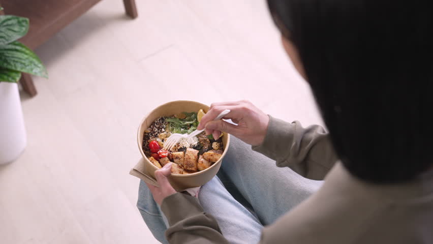 Woman eating healthy meal while working, Businesswoman having a lunch break at the office