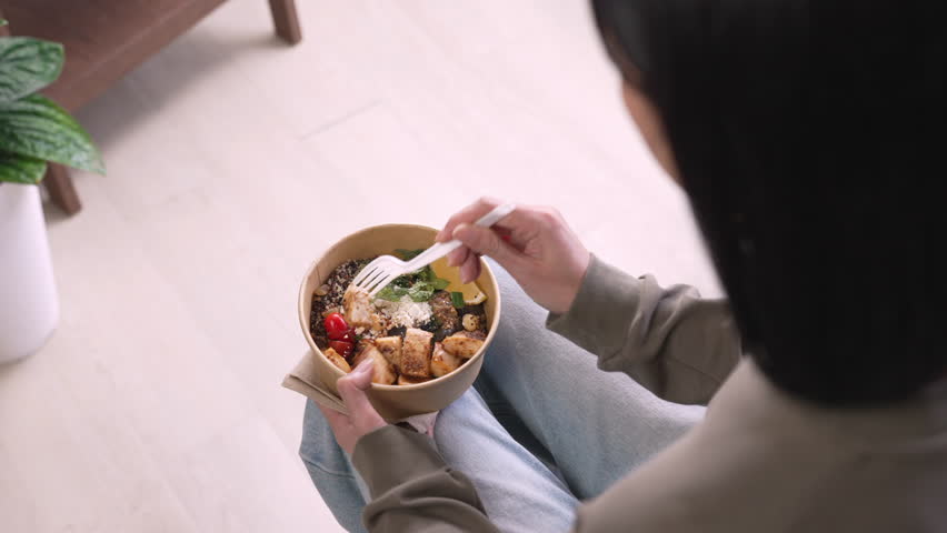 Woman eating healthy meal while working, Businesswoman having a lunch break at the office