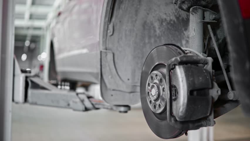 Car brake disc replacement sequence in auto repair workshop