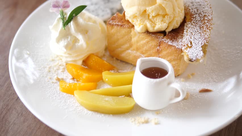 Delicious Honey Toast with Ice Cream and Fresh Fruits on White Plate – Dessert and Sweet Food Concept