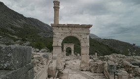Drone glides through ancient archways of Sagalassos. Stone ruins reflect Roman heritage in Turkiye. A timeless frame in highland archaeological sites. - Powered by Shutterstock - Get 15% off with code: PIKWIZARD15