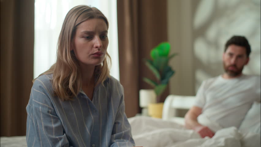 Family argument stressed Caucasian couple in bedroom divorce frustrated husband ignore sad worried woman wife relationship psychological problem breakup pair quarrel arguing morning man avoid speaking