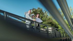 Architects and engineer reviewing blueprints on a bridge - Powered by Shutterstock - Get 15% off with code: PIKWIZARD15