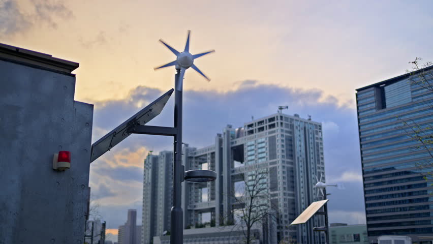 Close up of a small-scale renewable energy station with a wind turbine and a solar panel in Daiba, Tokyo, Japan