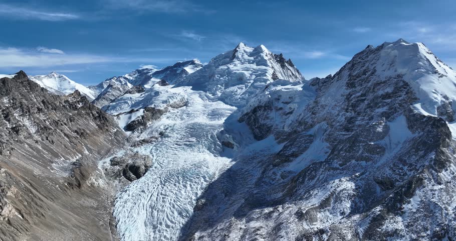 Beautiful high altitude hanging glacier and snow capped mountain with lake in Tibet, China