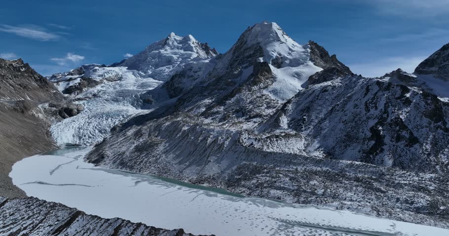 Beautiful high altitude hanging glacier and snow capped mountain with lake in Tibet, China