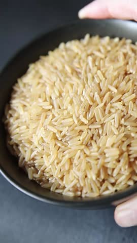 Brown rice whole grain cereal healthy product superfood fresh tasty gourmet food background on the table rustic food top view copy space keto and paleo diet vegetarian and vegan food