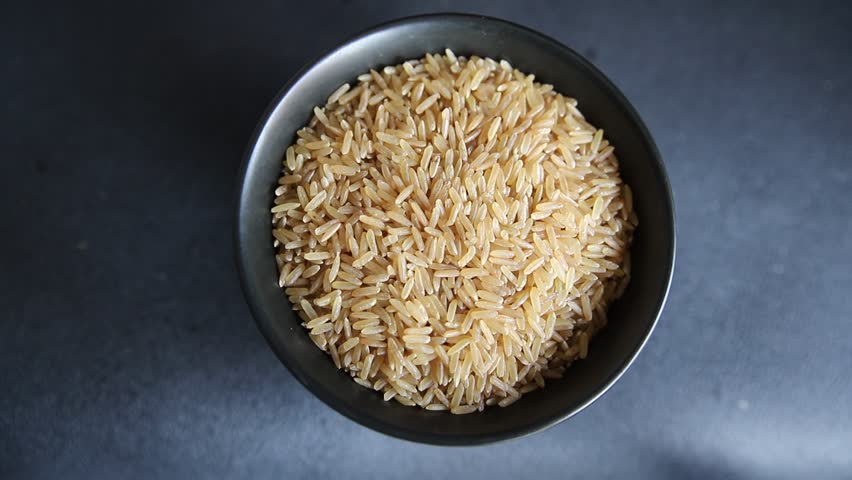 Brown rice whole grain cereal healthy product superfood fresh tasty gourmet food background on the table rustic food top view copy space keto and paleo diet vegetarian and vegan food