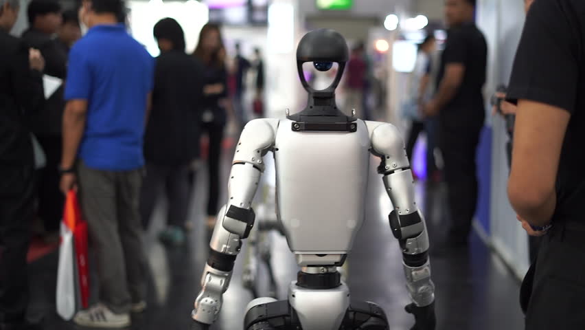 Robot walks through a crowd of people in a modern city.