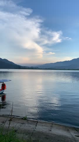 A bright early morning at the lake and mountains, under the Indonesian sky.