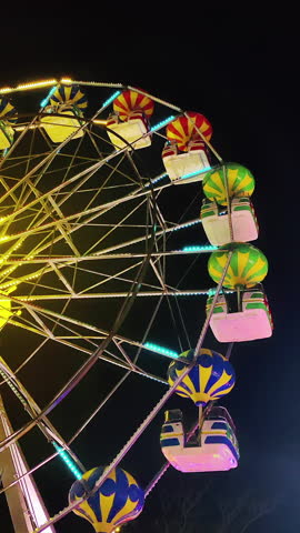Amusement Park Ferris Wheel Spins in Dark Sky Footage.