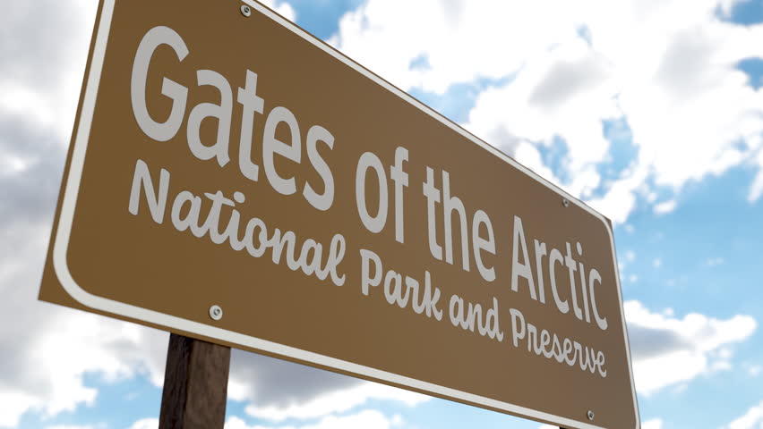 Gates of the Arctic National Park and Preserve (Alaska) Road Sign Against Blue Sky and Clouds. One of The US National Parks Series.