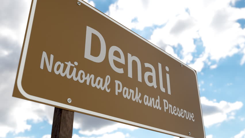Denali National Park and Preserve (Alaska) Road Sign Against Blue Sky and Clouds. One of The US National Parks Series.
