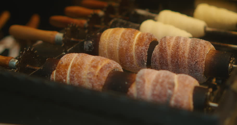 Traditional Czech chimney cakes are freshly baked on rotating spits, covered in sugar and cinnamon