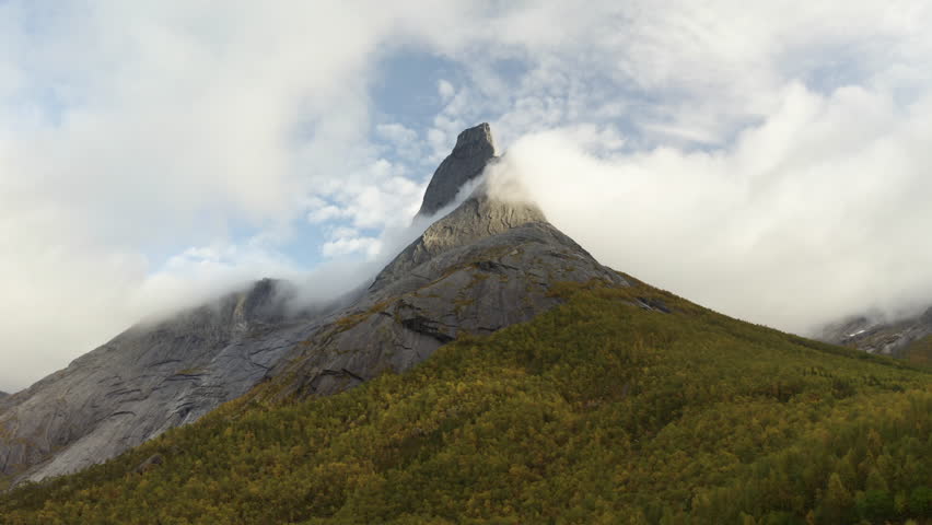 Aerial view approaching the Stetinden mountain peak, foggy, fall day in Norway