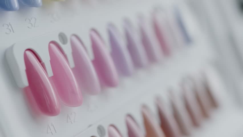 Close-up image of a range of colorful nail polish samples displayed on a beauty salon palette. Ideal for beauty, fashion, and nail care concepts. Colorful Nail Polish Samples in Soft and Pastel Shades
