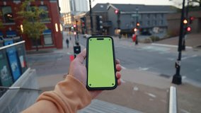 Close-Up POV Of A Man Holding A Green Screen Phone On A Crowded Night Street. Blurred City Lights Form A Vibrant And Modern Urban Setting. - Powered by Shutterstock - Get 15% off with code: PIKWIZARD15