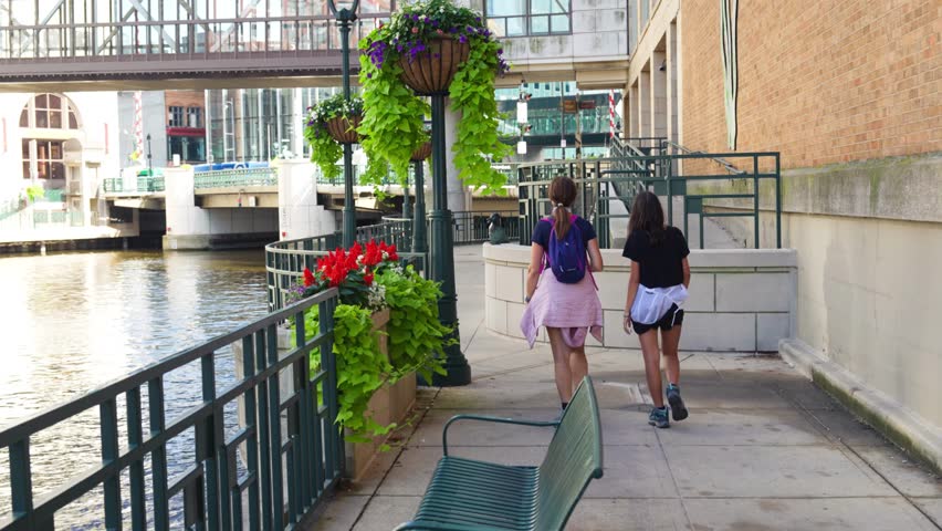 Family time: Mother and daughter walking together on Milwaukee’s riverside path